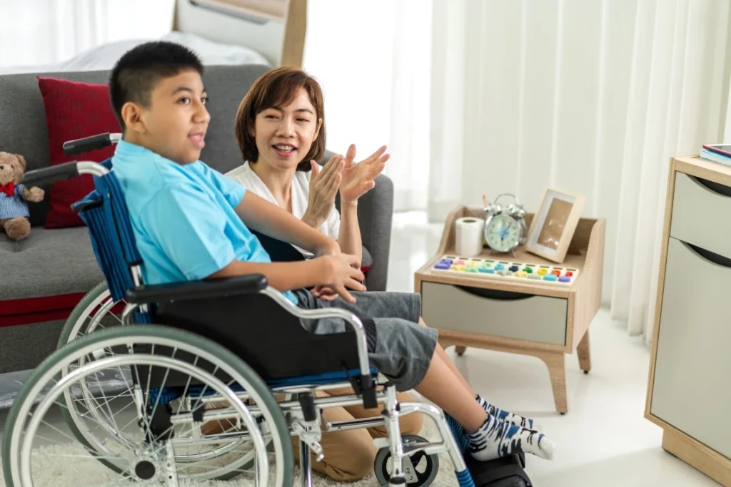 Nurse in home with boy in wheelchair