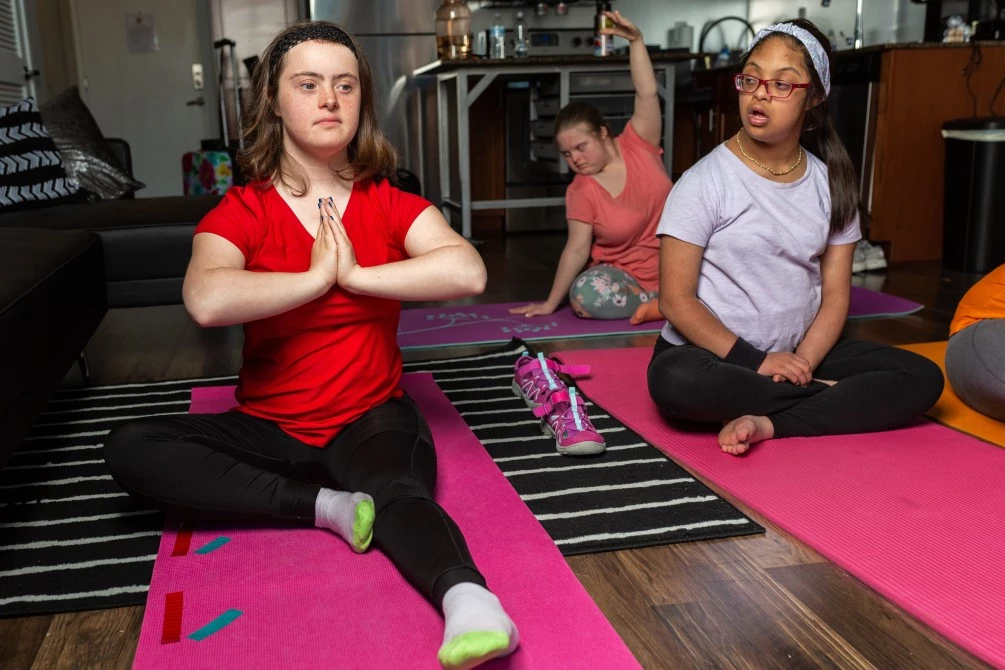 Two girls with down syndrome enjoying a Pilates class